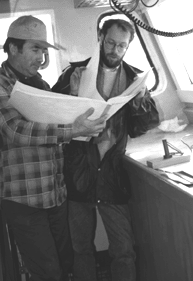 IMAGE: Fisherman Paul Tough (left) and Sean Smith, Data Analyst/Coordinator for the Halifax-based Fishermen and Scientists Research Society, review a record book the Tough keeps for the organization. Many collaborative projects involve collection of data by fishermen while they are at sea.