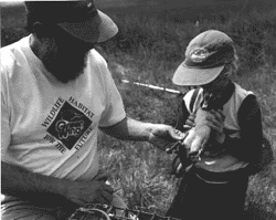 Image - Reg Melanson, Eastern Habitat Joint Venture Coordinator, introduces Alice Stone to a wood duck at Belleisle Marsh, an EHJV project along the Annapolis River in Nova Scotia.