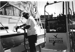 Image - Friends of Casco Bay's pumpout boat, manned above by Vessel Pumpout Program Coordinator Andy Bertocci, provides a convenient and environmentally safe way for boaters to empty their septic waste tanks.