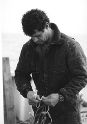 Image: Fisherman Willie Amaro repairs a trawl net aboard Albatross IV. Survey cruises weather many of the same problems commercial fishing vessels encounter at sea, including losing nets to a rocky ocean floor.